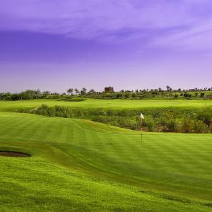 a view of a golf course with a green field at ART NORIA Private garden - pool view in Marrakech