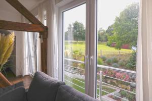 a room with a sliding glass door with a view of a garden at Ferienloft Lippe in Lage +16 photos