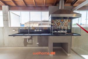a kitchen with a sink and a counter top at Casa em Maresias com Churrasqueira e area de lazer in Maresias