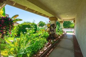 an outdoor porch with a garden of plants at Near ONT Spacious Designer-Style Family Retreat in Guasti