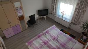 a living room with a bed and a television at Moderne Altbauwohnung 80qm in Löhne