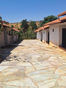 einen Steinweg vor einem Gebäude in der Unterkunft Suítes Recanto das Flores 3 in Pirenópolis