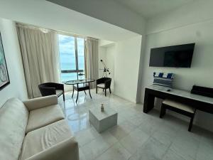 a living room with a couch and a table at Park Royal 809 Vista al Mar in Mazatlán