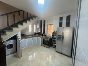 a kitchen with a staircase and stainless steel appliances at Sunbeams in Id Taleb