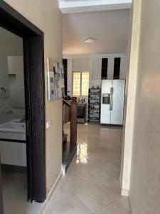 a large kitchen with a sink and a refrigerator at Sunbeams in Id Taleb +8 photos