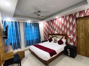 a bedroom with a bed with blue and red curtains at Hotel Shanti Stay, Near Delhi Airport in New Delhi