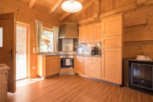 eine große Küche mit Holzschränken und einem Kamin in der Unterkunft Chalet Leitn-Anger in St. Leonhard in Passeier + 37 Fotos