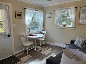 a living room with a table and a couch at Quaco Cottages - The Waterloo in Saint Martins +29 photos