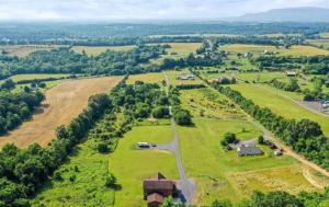 an aerial view of a field with a house and a road at Homestead with Shenandoah Valley Views in Strasburg