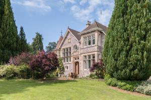 a large stone house with a large tree at Firlands in Forres