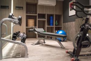 a gym with several exercise equipment in a room at Frida by Viadora in Mexico City +3 photos