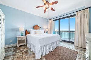 a bedroom with a bed and a ceiling fan at Grand Pointe Unit 706 in Orange Beach