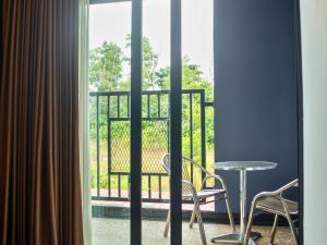 a room with a balcony with a table and chairs at Bona Ventura Hotel & Skybar in Tanjung Pinang 