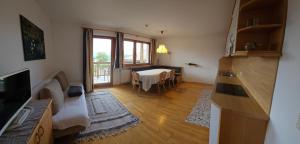 a living room with a table and a dining room at Pension Pepi - Apartments I Bed - Breakfast in Perca
