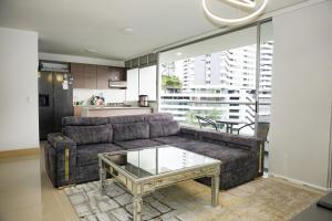 a living room with a couch and a table at Luxurious apartment in Las Palmas in Medellín