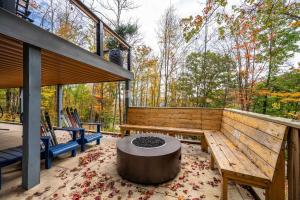 a screened in porch with a bench and a table at Spacious 6 Bedroom Chalet Near Holiday Valley in Ellicottville