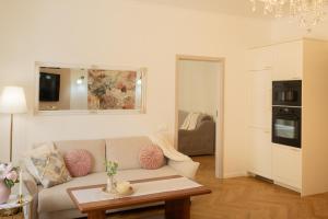 a living room with a couch and a table at Tynska apartment in Prague