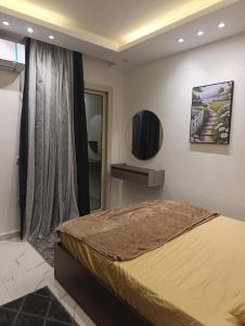 a bedroom with a large bed in a room at studio in villa in Asyut