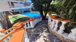 an external view of a house with a swimming pool at Palmas in Cuernavaca
