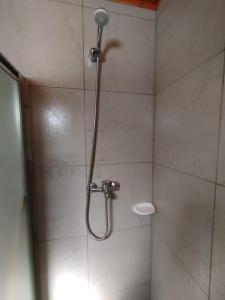 a shower with a shower head in a bathroom at Cabañas a 5 minutos del río in Alta Gracia +61 photos