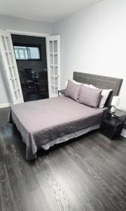 a bedroom with a large bed and a table at Modern 3BDRM, Renovated, Spacious & Central in Evansville