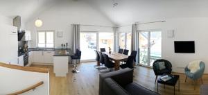 a living room and kitchen with a couch and a table at Walser Berghaus in Riezlern