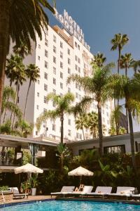a hotel with palm trees and a swimming pool at The Hollywood Roosevelt in Los Angeles