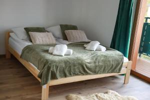 a bed with two pillows on top of it at Spis na Podhalu in Koniówka +11 photos