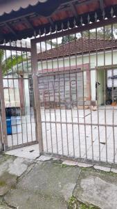 an iron gate in front of a building at Casa do Pescador in Bertioga