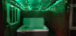 a bathroom with a tub with green lights on it at Dorset Escape in Poole +28 photos