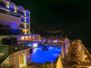 a hotel with a swimming pool at night at Meis Exclusive Hotel in Kaş