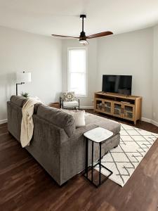 a living room with a couch and a flat screen tv at Modern 4 BDRM Renovated Spacious near U of E and Downtown in Evansville