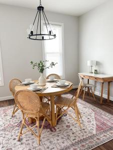 a dining room with a wooden table and chairs at Modern 4 BDRM Renovated Spacious near U of E and Downtown in Evansville