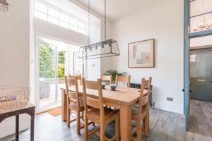 a dining room with a wooden table and chairs at Firlands in Forres