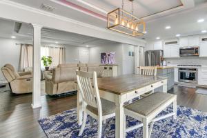 a kitchen and living room with a wooden table and chairs at Fenced Yard Home Less Than 1 Mi to Mayor Pablo Peña Park in Weslaco