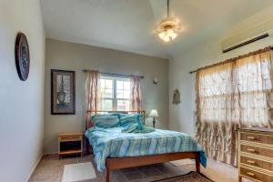 a bedroom with a bed and a window at View the Blue -Upper Level -Gold Standard Certified in Cayo Romero +16 photos