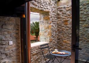 an open door to a patio with a table and a cup of coffee at Casa La Pascuala in Helgueras