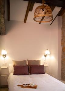a bedroom with a bed with a tray on it at Casa La Pascuala in Helgueras