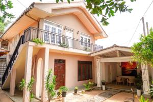 a house with a balcony on top of it at Exotica Bungalows -Hikkaduwa in Hikkaduwa