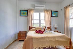 a bedroom with a bed with two towels on it at View the Blue -Ground Level -Gold Standard Certified in Cayo Romero