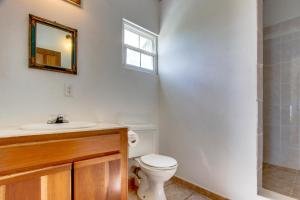 a bathroom with a toilet and a sink and a mirror at View the Blue -Ground Level -Gold Standard Certified in Cayo Romero +10 photos