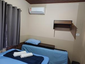 a room with two beds and a air conditioner at Casa da Família Carvalho - 986 in Belém +9 photos