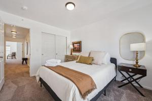 a bedroom with a large bed and a mirror at 3BR Modern Retreat, Close to DIA & Downtown Denver in Commerce City