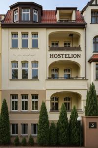 a large building with a hospital sign on it at Hostelion in Magdeburg