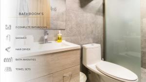 a bathroom with a white toilet and a sink at 102 Centro 2Bdrm 2bath apt AC Rooftop in Mexico City