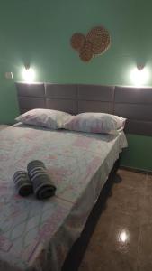 a bedroom with a bed with two pillows on it at Pousada Aconchego Manaíra in João Pessoa +2 photos