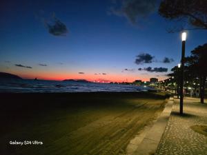 a street light next to the ocean at night at Luxury Two Bedrooms and two balcony beachfront apartment in Vlorë +7 photos