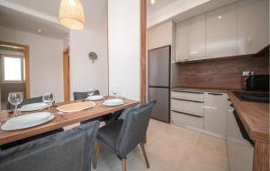 une cuisine avec une table en bois et des chaises ainsi qu'une salle à manger dans l'établissement Awesome Apartment In Vrsi With Sauna, à Kod Mula