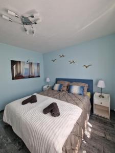 a bedroom with a large bed with two towels on it at Cozy modern newly renovated home in Kassel in Kassel