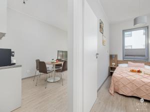 a bedroom with a bed and a table with chairs at Apartment in Pobierowo near Baltic Beach in Pobierowo